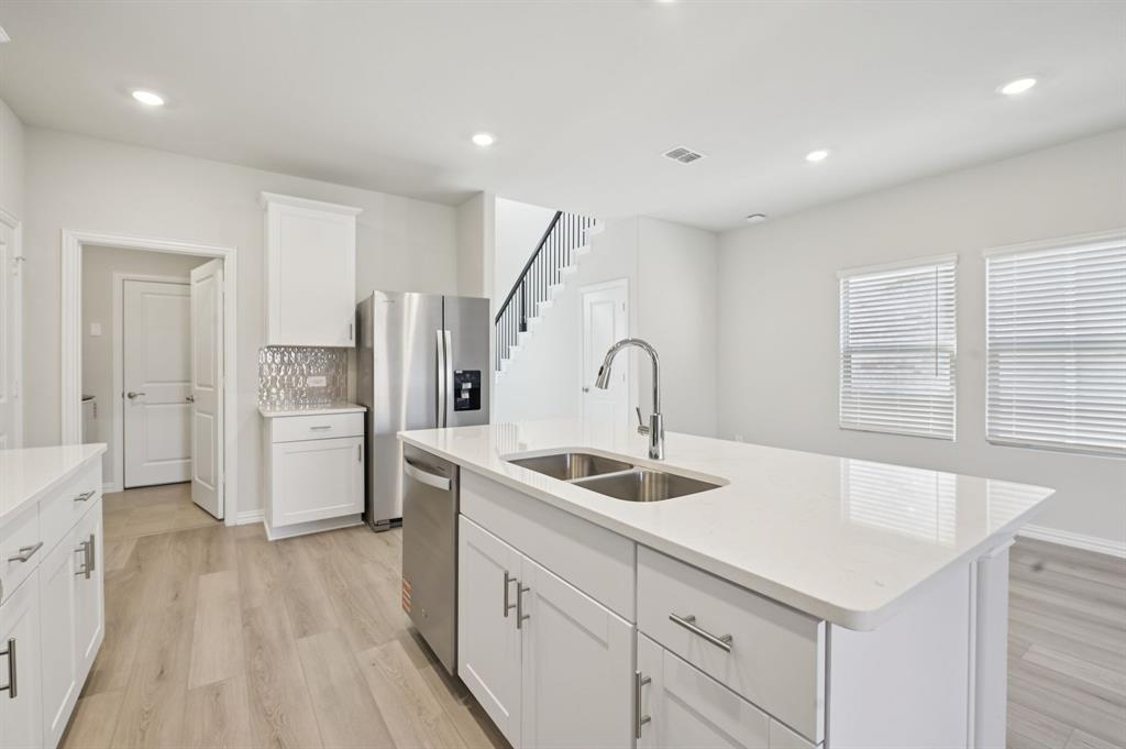1720 Arches Road Anna, TX 75409 - Photo 4 of 31 a kitchen with white cabinets and sink