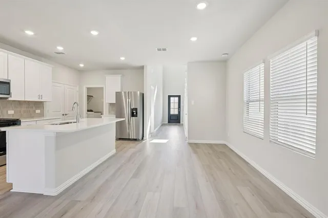 a large kitchen with a lot of counter space and a wooden floors
