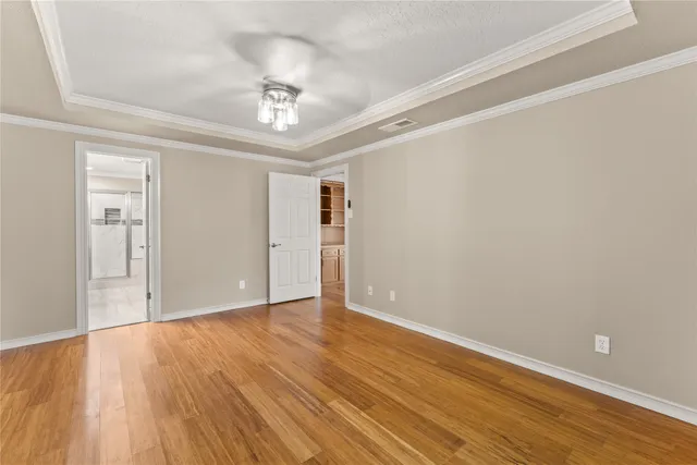a view of an empty room with wooden floor