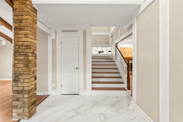 a view of a hallway with entryway wooden floor and front door