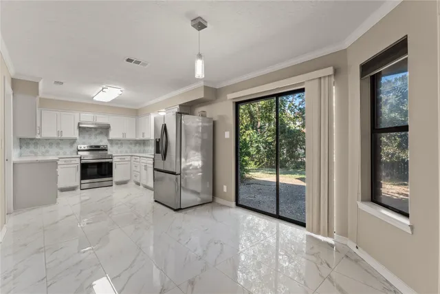 a kitchen with refrigerator a sink and cabinets
