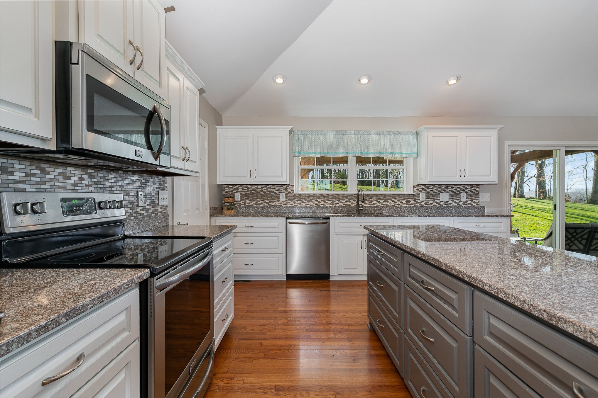 1525 Heller Ridge Spring Hill, TN 37174 - Photo 11 of 57 a kitchen with stainless steel appliances granite countertop a stove a sink and a microwave