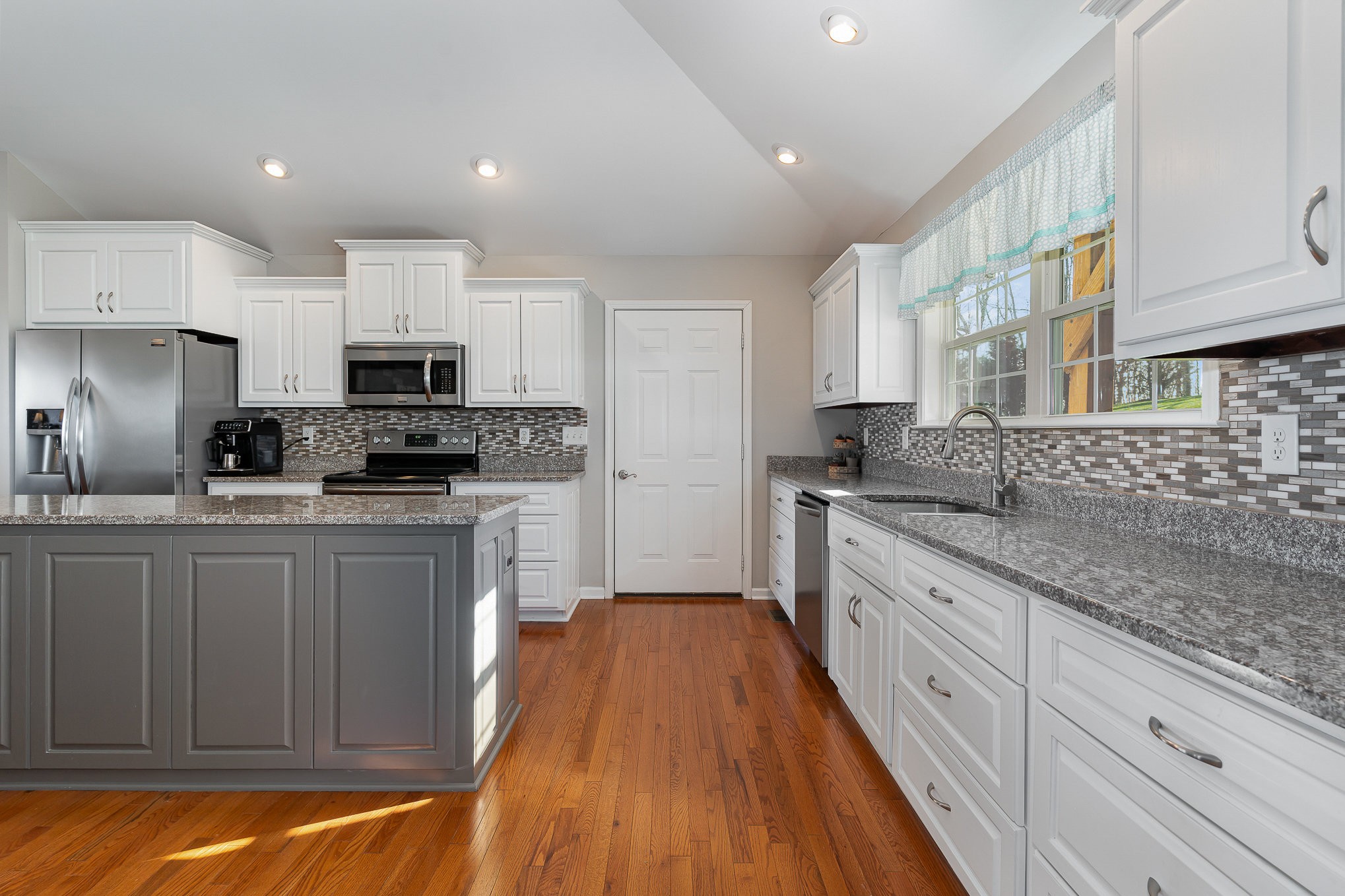 1525 Heller Ridge Spring Hill, TN 37174 - Photo 12 of 57 a kitchen with sink a microwave and cabinets