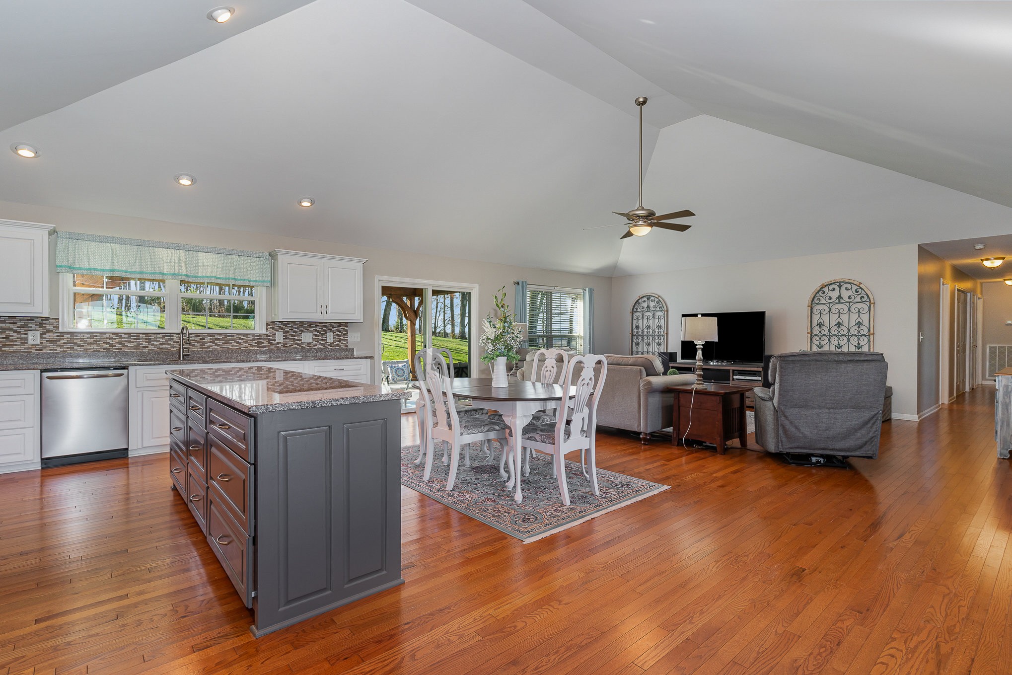1525 Heller Ridge Spring Hill, TN 37174 - Photo 8 of 57 a kitchen with stainless steel appliances granite countertop a stove top oven a sink dishwasher a dining table and chairs with wooden floor