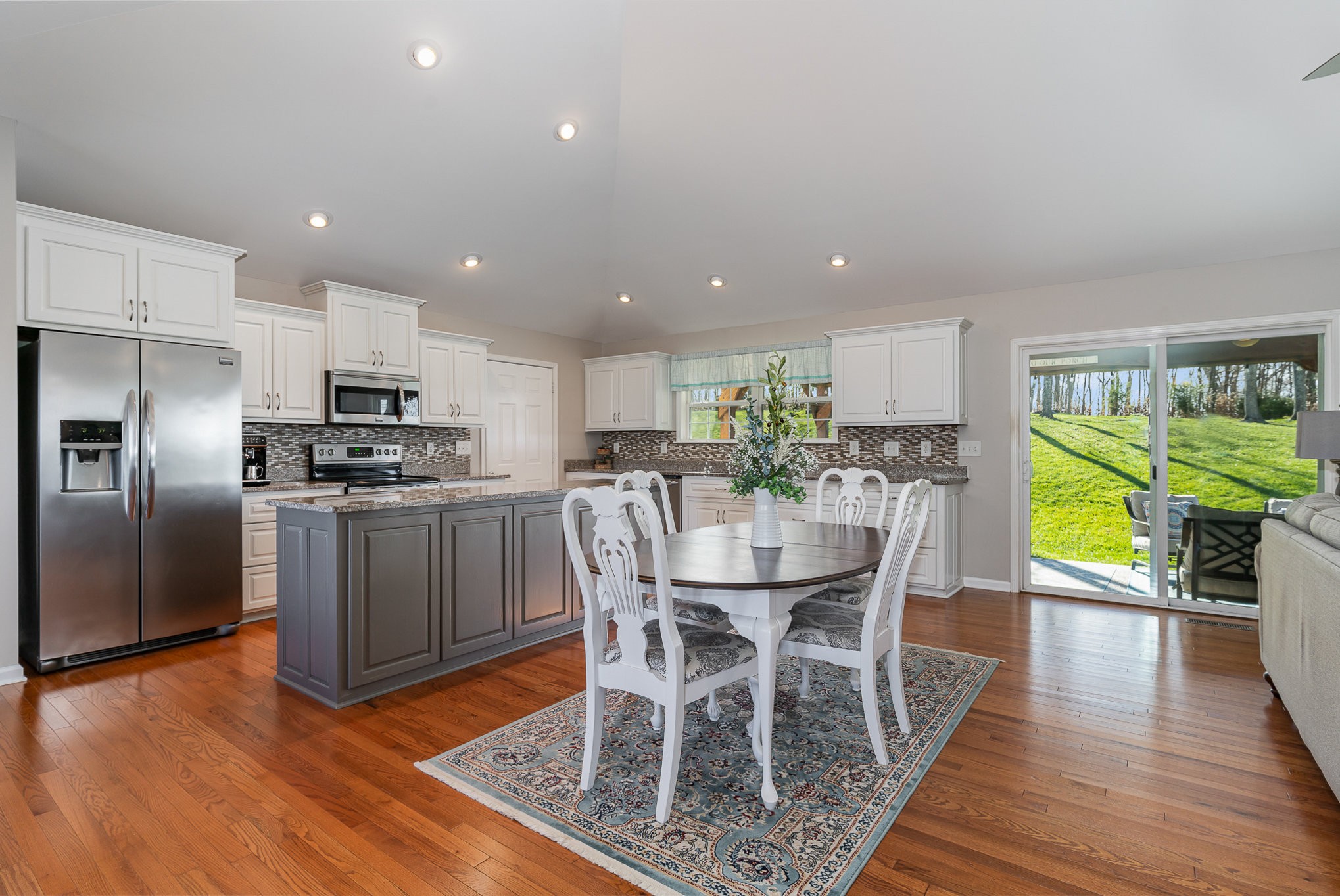 1525 Heller Ridge Spring Hill, TN 37174 - Photo 9 of 57 a kitchen with a dining table chairs and refrigerator