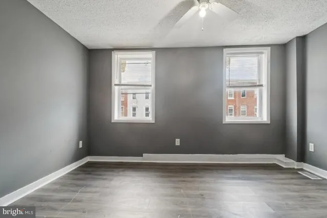 a view of a livingroom with wooden floor and a window