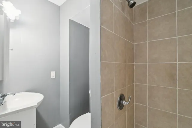 a bathroom with a shower toilet and sink