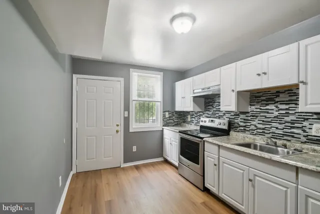 a kitchen with cabinets appliances and a window