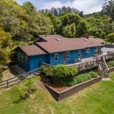 a aerial view of a house with a yard table and chairs