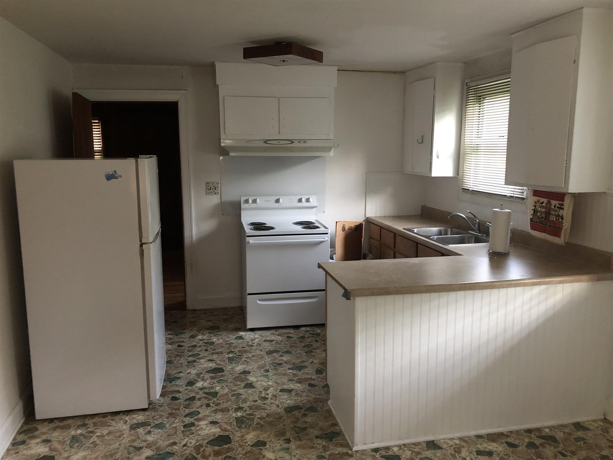 637 Neelys Bend Road Madison, TN 37115 - Photo 3 of 15 a kitchen with a refrigerator sink and cabinets