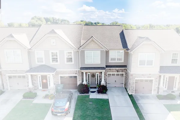a front view of a house with a garden