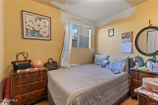 a bedroom with a bed and a dresser