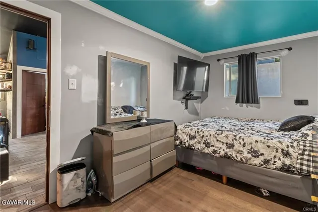 a bedroom with bed and mirror