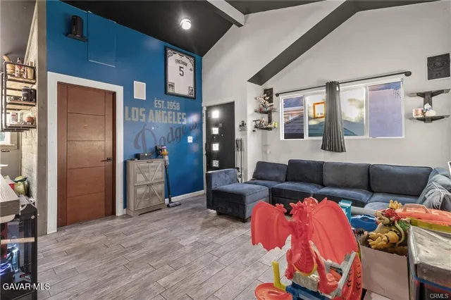 a bedroom with furniture and a wooden floor