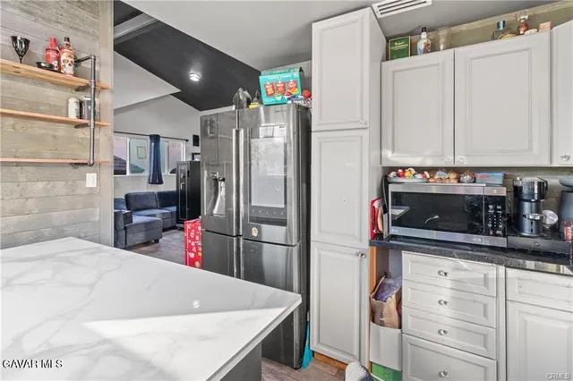 a kitchen with refrigerator and cabinets