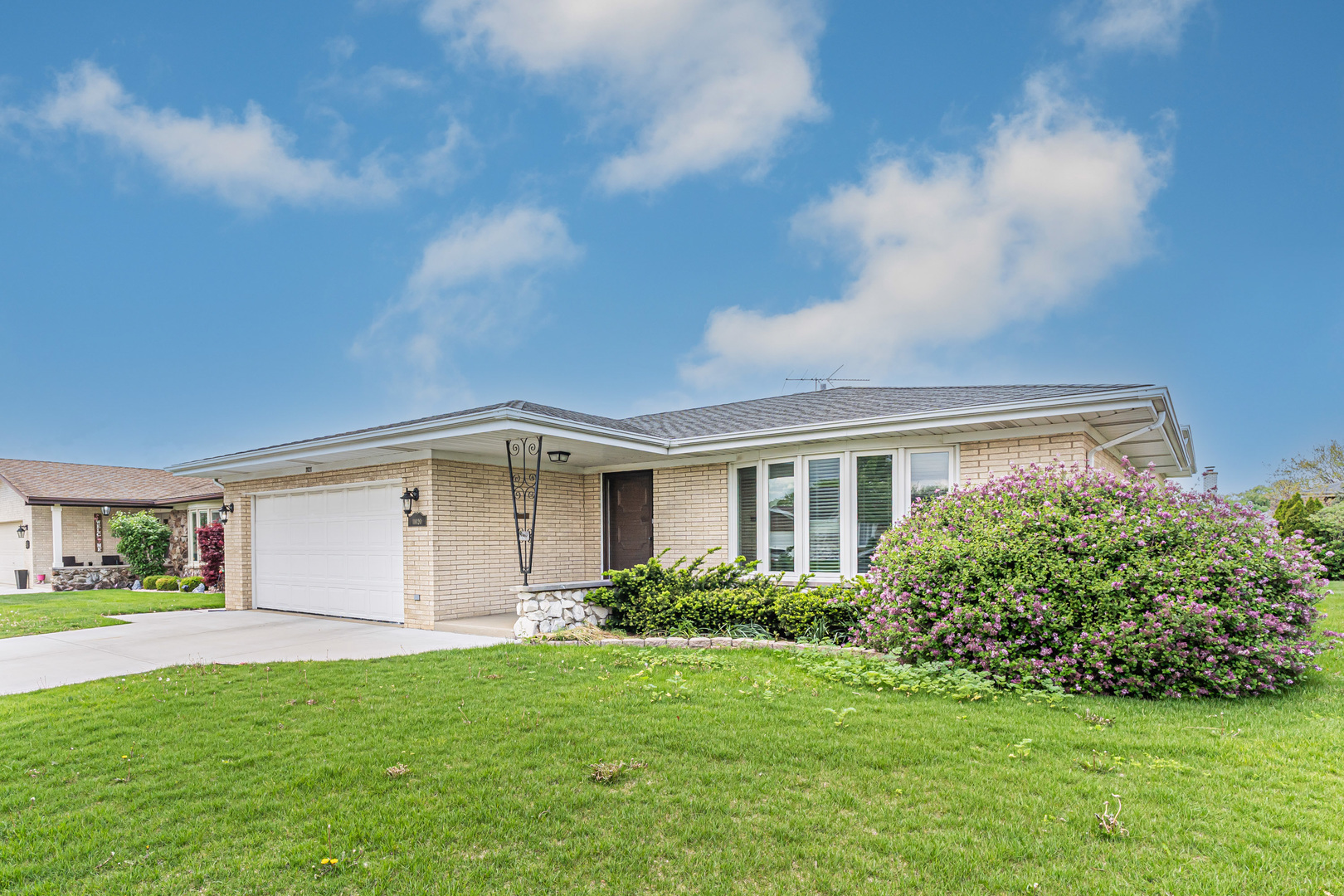 a front view of house with yard and green space