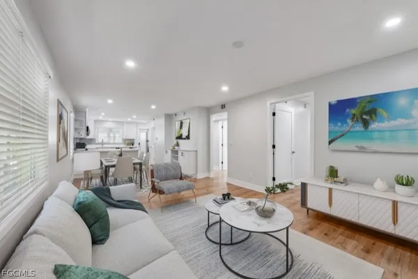 a living room with furniture and kitchen view