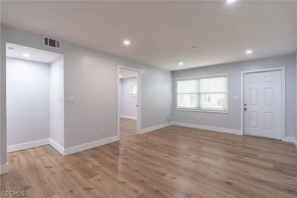 a kitchen with a white stove top oven and white cabinets