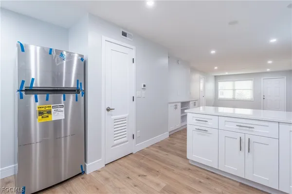 a kitchen with stainless steel appliances granite countertop a refrigerator and a stove top oven