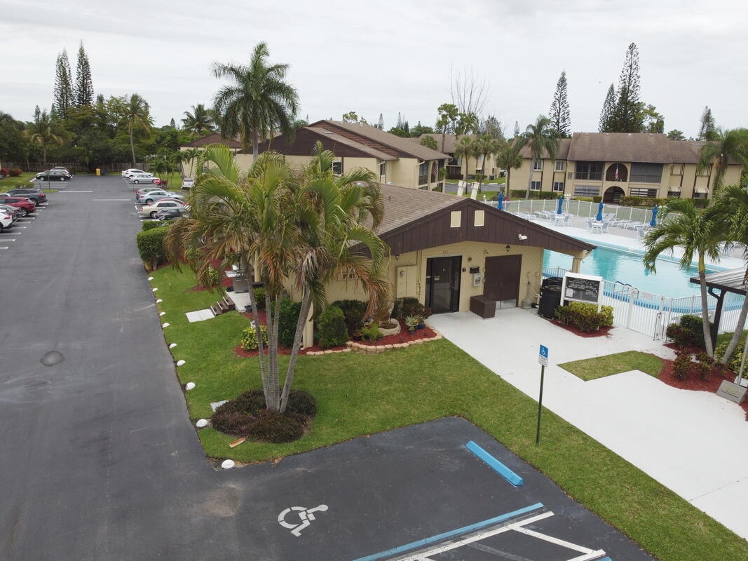 320 Pine Ridge Circle, Unit A1 Greenacres, FL 33463 - Photo 56 of 65 a front view of a house with a yard