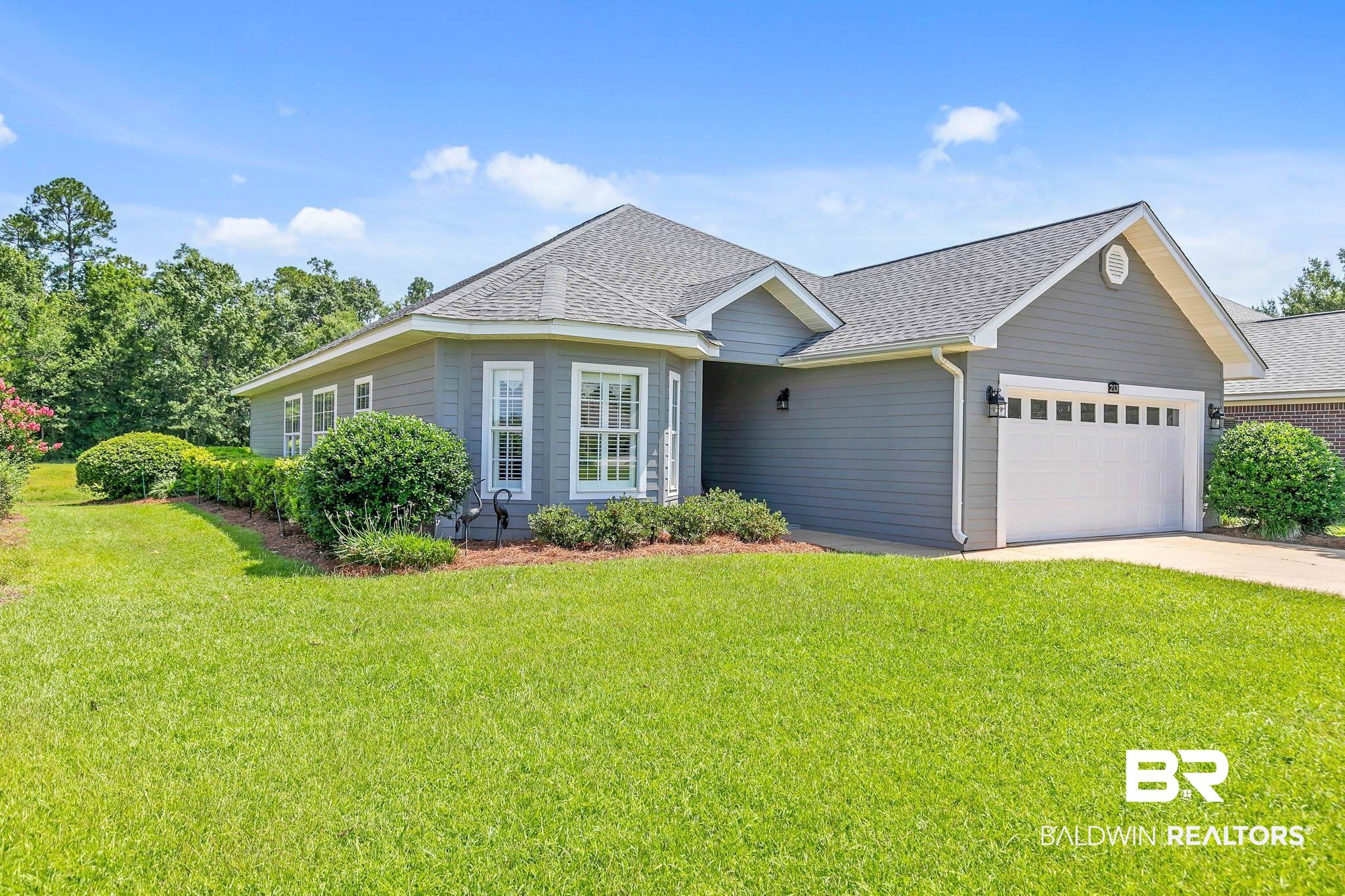 213 Hemingway Loop Foley, AL 36535 - Photo 2 of 69 View of front facade with a shingled roof, an attached garage, a front lawn, and driveway