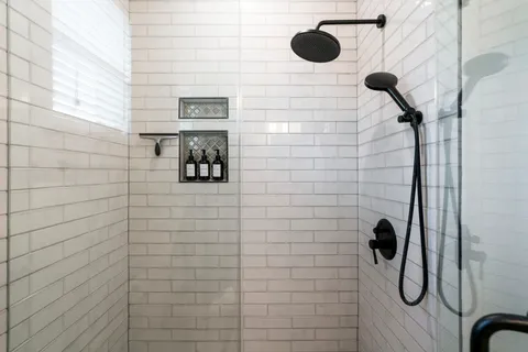 a bathroom with a granite countertop sink a toilet and a mirror