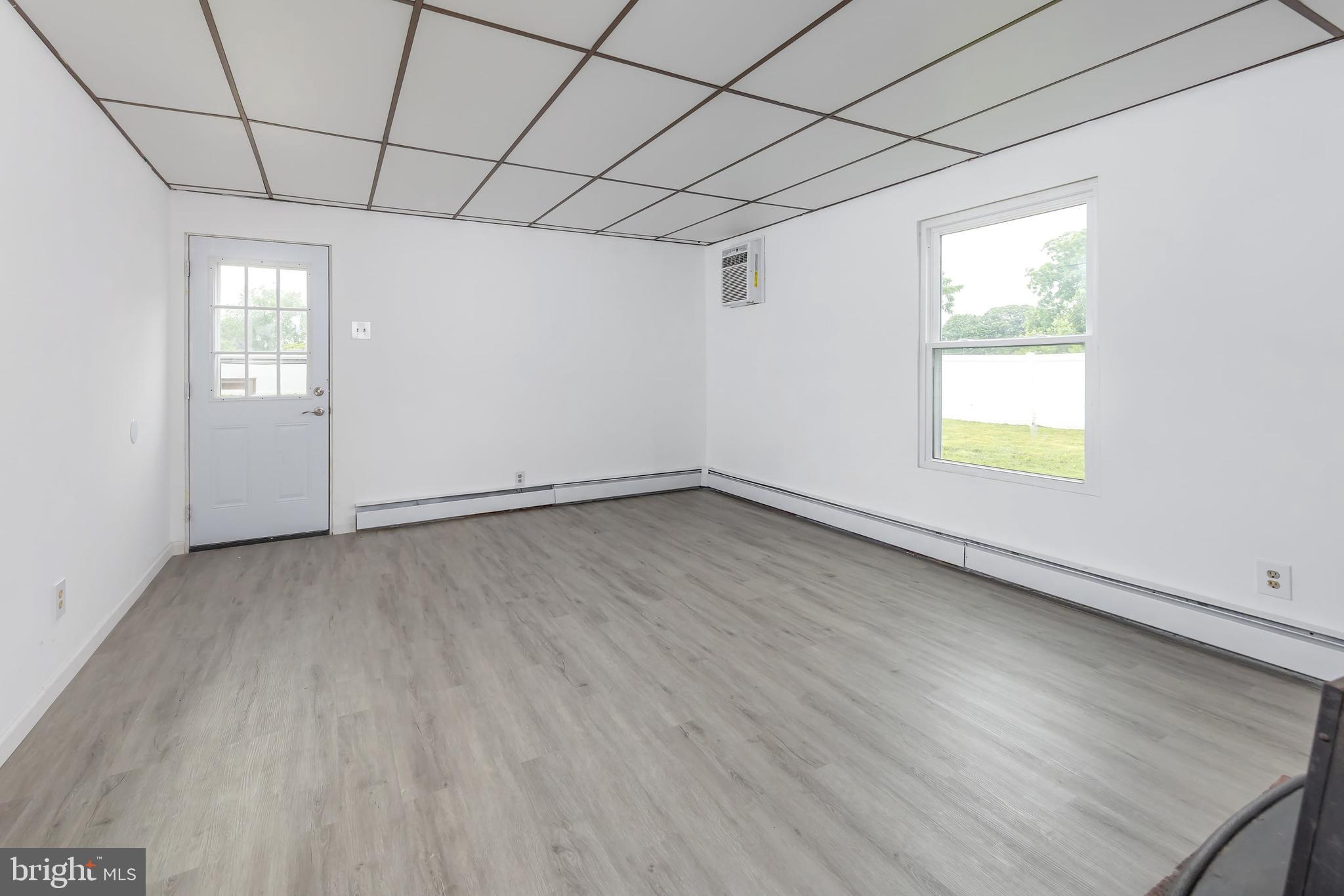 1510 Good Intent Road Deptford, NJ 08096 - Photo 15 of 20 an empty room with wooden floor and windows