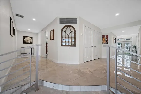 a large bedroom with a bed and a chandelier
