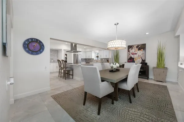 a large kitchen with a table and chairs