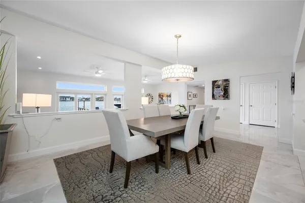 a kitchen with a refrigerator sink and white cabinets