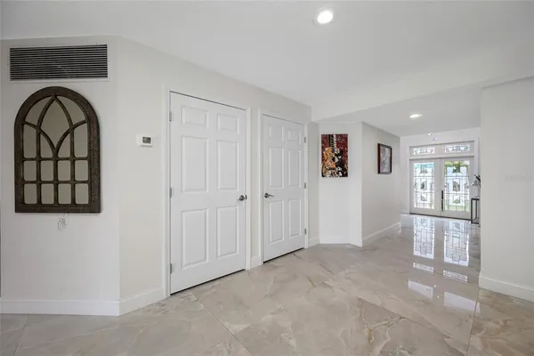 a view of a hallway with wooden floor and a living room