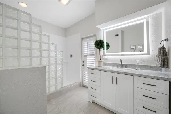 a view of a house with swimming pool and sitting area