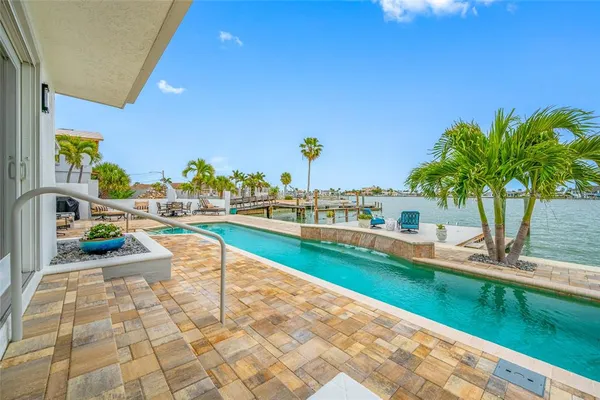 a swimming pool with outdoor seating and yard