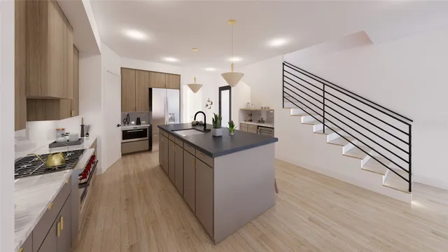 a kitchen with stainless steel appliances granite countertop a refrigerator a stove and a wooden floors