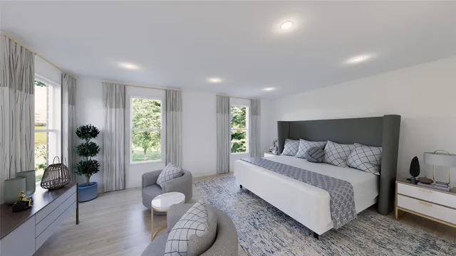 a spacious bedroom with a bed and wooden floor