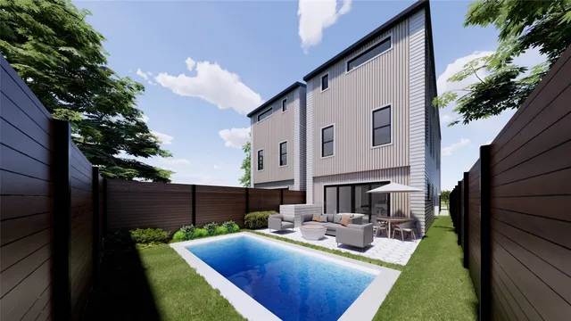 a view of a house with backyard and sitting area