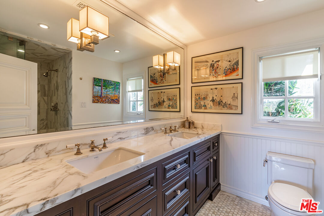 1612 Gilcrest Drive Beverly Hills, CA 90210 - Photo 19 of 33 a bathroom with a granite countertop double vanity sink a toilet and a window