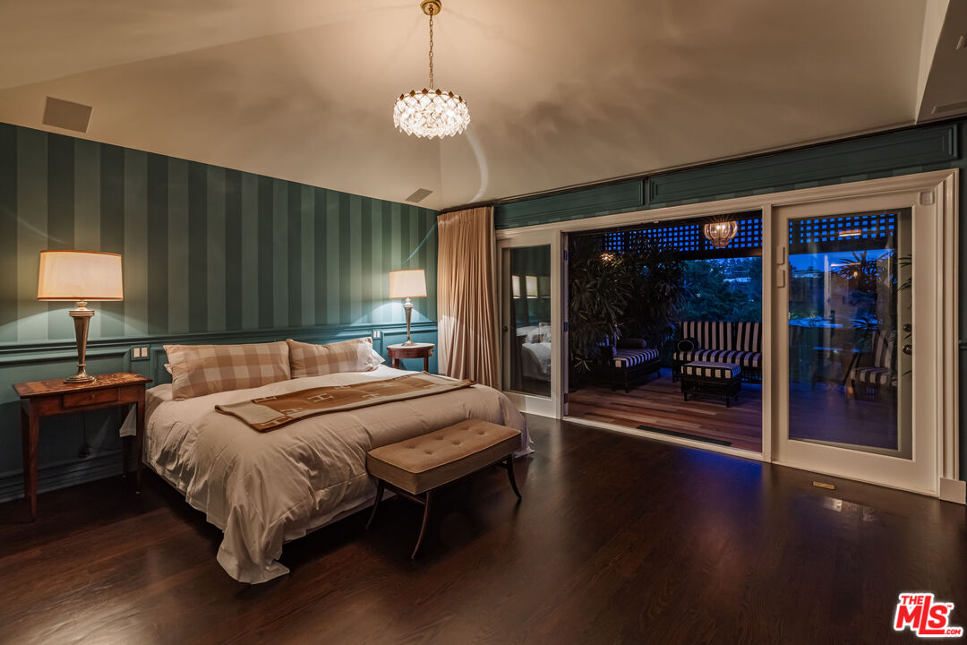 1612 Gilcrest Drive Beverly Hills, CA 90210 - Photo 26 of 33 a bed sitting in a spacious bedroom next to a lamp