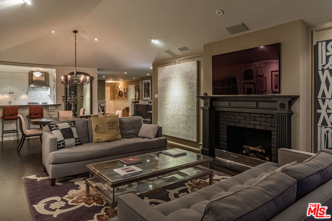 1612 Gilcrest Drive Beverly Hills, CA 90210 - Photo 28 of 33 a living room with furniture and a fireplace