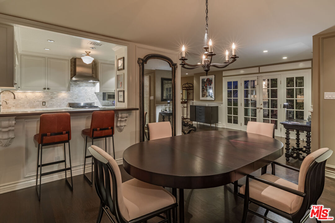 1612 Gilcrest Drive Beverly Hills, CA 90210 - Photo 29 of 33 a view of a dining room with furniture and chandelier