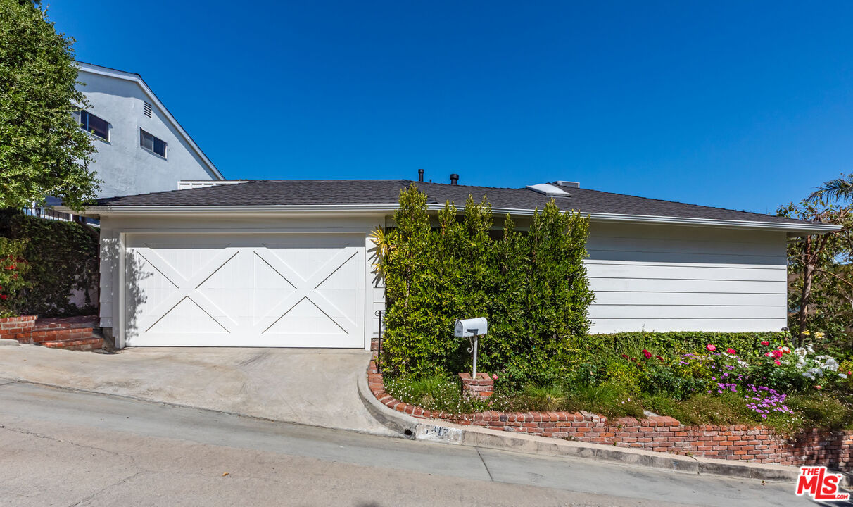 1612 Gilcrest Drive Beverly Hills, CA 90210 - Photo 33 of 33 a view of a house with a yard and plants