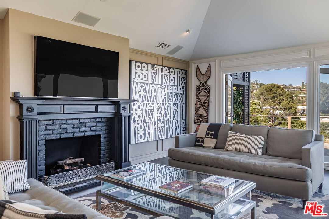 1612 Gilcrest Drive Beverly Hills, CA 90210 - Photo 5 of 33 a living room with furniture and a fireplace