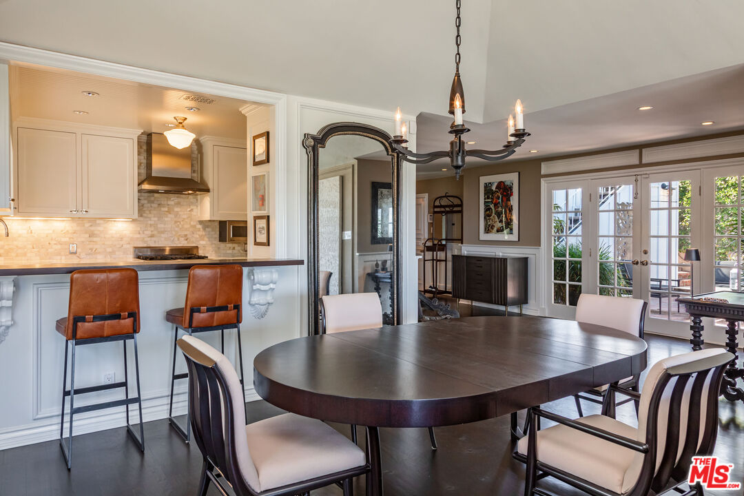 1612 Gilcrest Drive Beverly Hills, CA 90210 - Photo 8 of 33 a view of a dining room with furniture wooden floor and chandelier