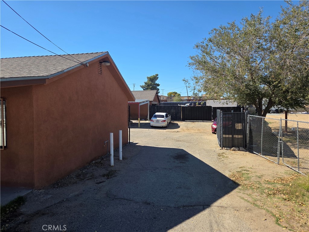 14258 Hesperia Road Victorville, CA 92395 - Photo 4 of 6 a view of roof deck with a barbeque and wooden fence