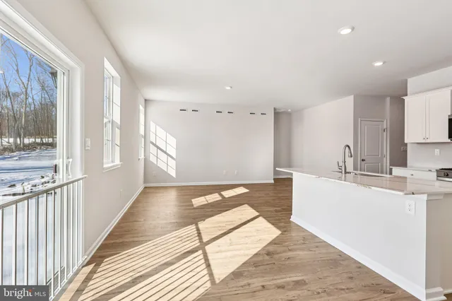 a kitchen with stainless steel appliances granite countertop a sink and a stove top oven