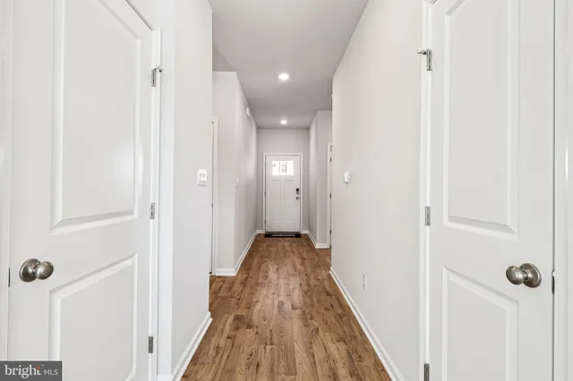 a view of kitchen with granite countertop a stove top oven and white kitchen