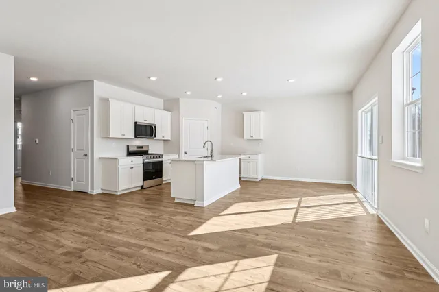 a view of kitchen with cabinets and wooden floor