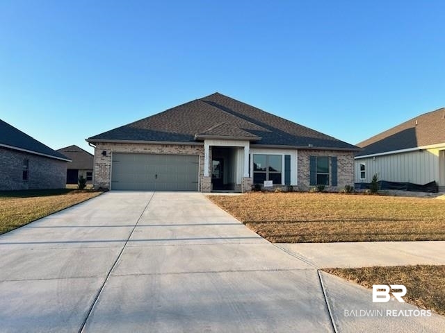 113 Preston Way Gulf Shores, AL 36542 - Photo 1 of 37 Ranch-style house featuring an attached garage, concrete driveway, brick siding, and a front yard