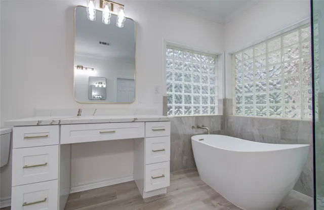 a spacious bathroom with a bathtub and a sink