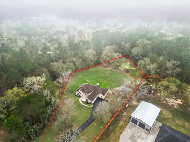 an aerial view of a house with a yard